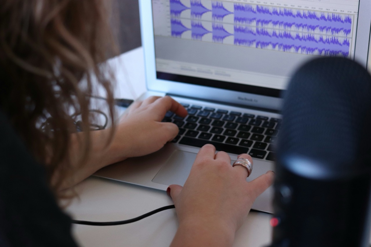 Woman working on an audio recording and transcribing it